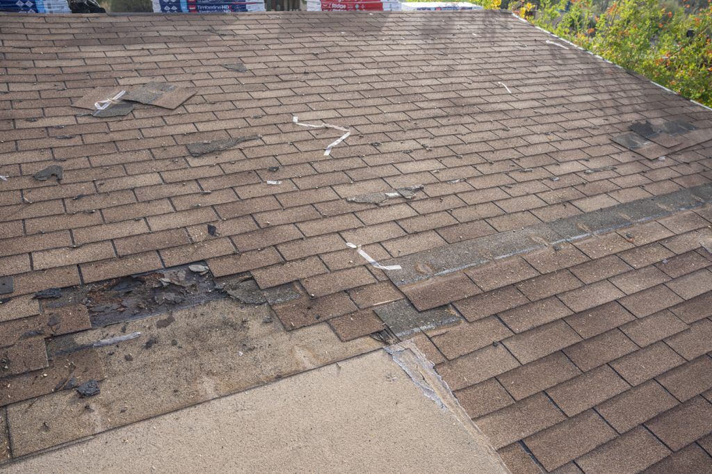 A roof that needs to be replaced due to storm damage, leading to the question "How to negotiate roof replacement with insurance"